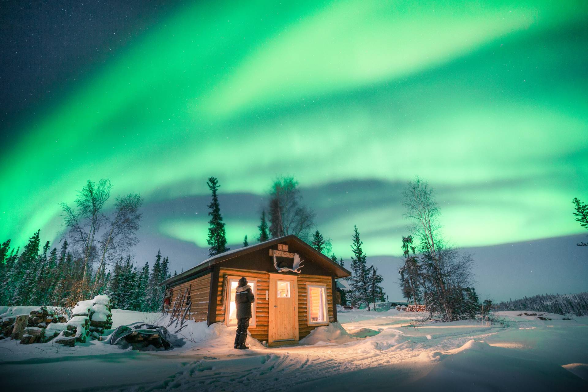 The northern lights glowing green across the night sky